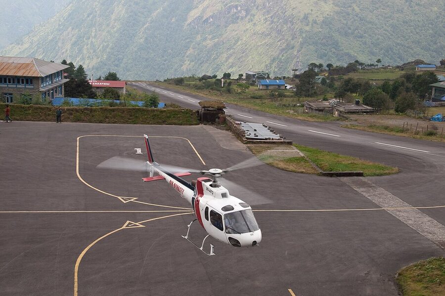 Helicopter parked on the sloping runway at Lukla Airport, Nepal