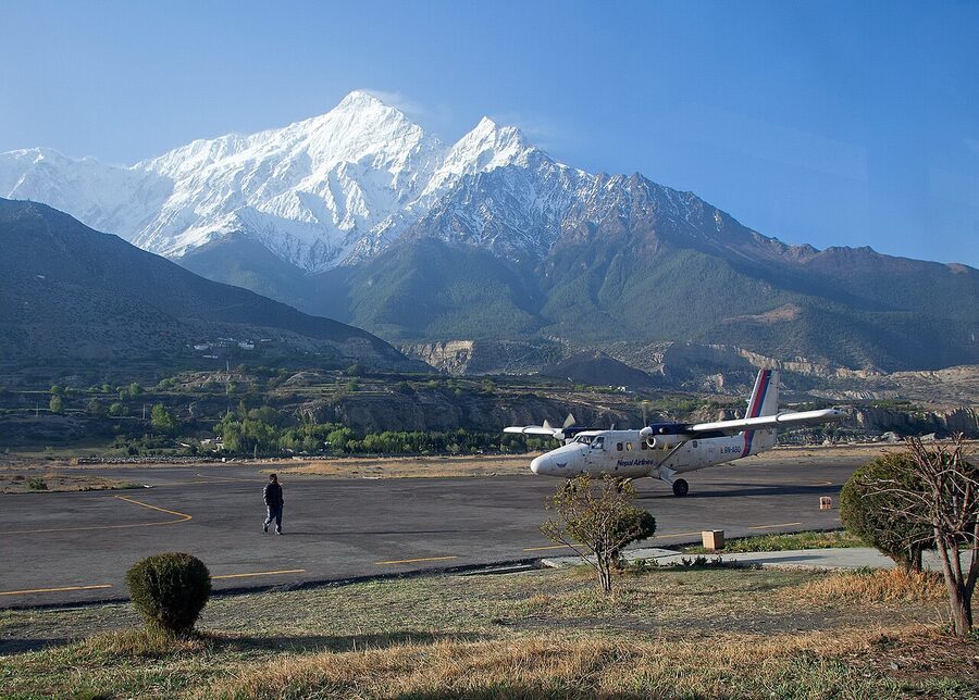 Nepal Airlines DHC-6 Twin Otter parked at Jomsom airport with Nilgiri mountain behind